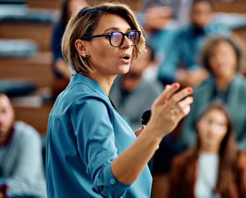 Woman speaking in front of classroom